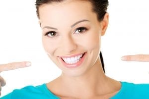woman smiling and pointing to smile