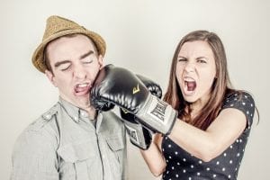 image of a woman punching a man in the face with boxing gloves