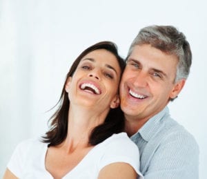 middle-age couple hugging and smiling