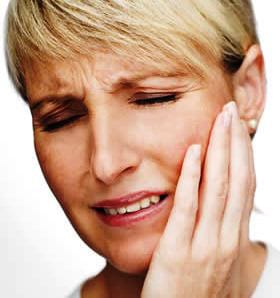 woman in pain holding her jaw